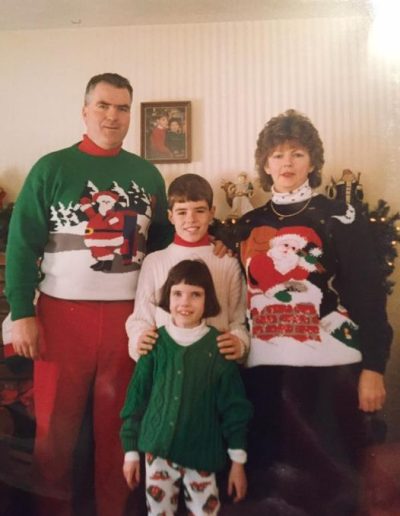 Kelly O'Brien as a child with her family in Christmas sweaters.