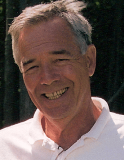 A closeup photo of a mature Bob Foley smiling at the camera.