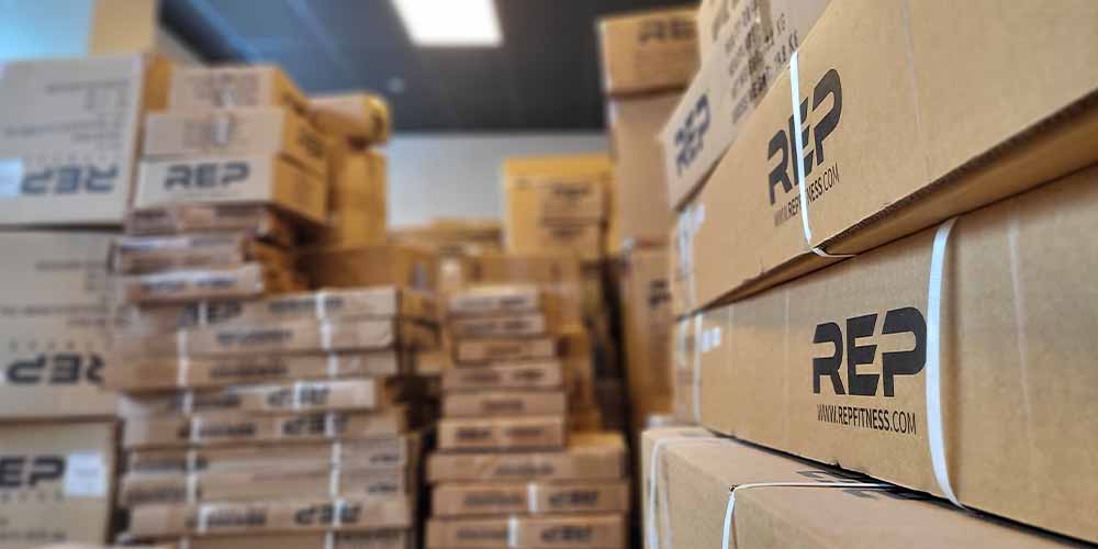 Photo Copyright: AIS Brightly lit AIS Showroom featuring vignettes of modern office furniture and a large blue column in the middle with a backlit AIS sign. (Photo copyright: AIS)