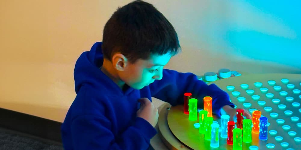 Photo Copyright: AIS Brightly lit AIS Showroom featuring vignettes of modern office furniture and a large blue column in the middle with a backlit AIS sign. (Photo copyright: AIS)