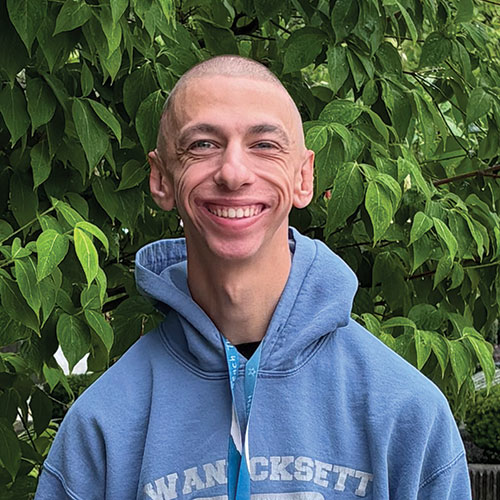 Headshot of CAPS Momentum member, Cole, smiling in front of a tree